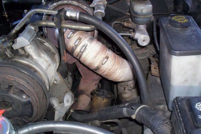 left exhaust manifold and exhaust heading out left wheel well.jpg